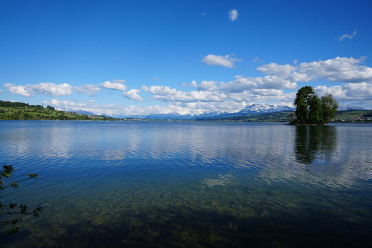 Lake Sempach with clear water and Mount Pilatus near Sursee Switzerland