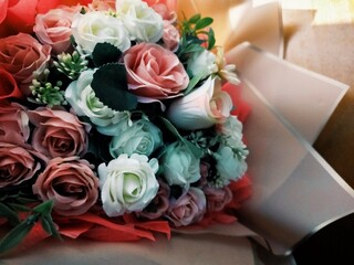 Colorful Artificial Rose Bouquet Wrapped in Paper Close-Up © Kaia