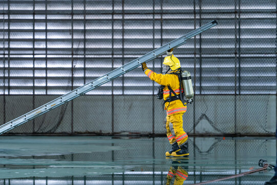 Firefighters Raising Ladder During Building Rescue and Emergency Response Training Exercise