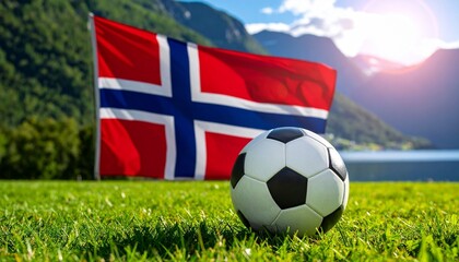 Fototapeta premium Soccer ball on green grass before Norwegian flag, symbolizing national pride, sportsmanship, and Norway’s passion for football and unity.