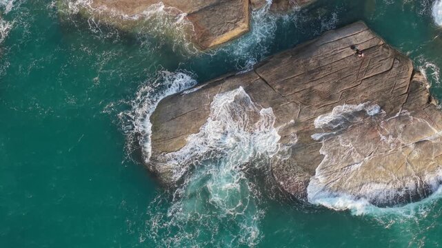 Aerial Top Down View of Large Granite Rock with Ocean Waves Ko Samui Thailand