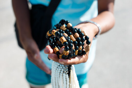Beach souvenir vendor offering handmade jewelry and shark tooth necklaces in tropical Philippines