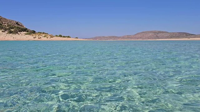 Enjoy the stunning clarity of the waters at Simos Beach, located on the beautiful island of Elafonisos Greece. The inviting blue hues and serene surroundings create a perfect summer getaway.