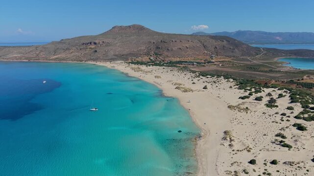 Experience the beauty of Simos Beach in Elafonisos, Greece, where crystal clear waters and golden sands create a paradise. The serene surroundings invite relaxation and exploration.
