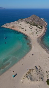 Discover pristine waters and golden sands at Simos Beach Greece, a hidden gem on Elafonisos Island. The breathtaking landscape and serene atmosphere invite you to relax under the summer sun.