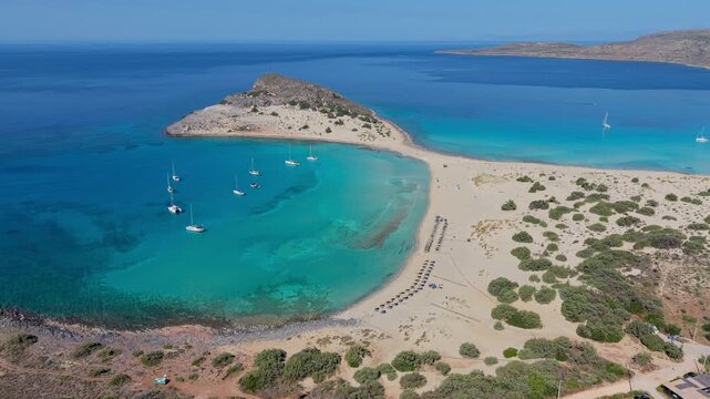 Discover the stunning landscape of Simos Beach in Elafonisos, Greece. Witness golden sands, turquoise waters, and scenic hills while enjoying the tranquility of this idyllic paradise.