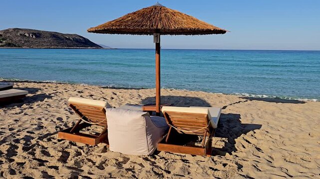 Soft sands and gentle waves invite relaxation at Simos Beach in Elafonisos, Greece. Lounge beneath a straw umbrella, soaking in the sun and tranquility of this beautiful destination.