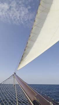 Classic Sailing Ship Bowsprit and Headsail Cutting Through Open Sea - Deck View