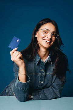 Woman holding credit card in banking finance portrait studio
