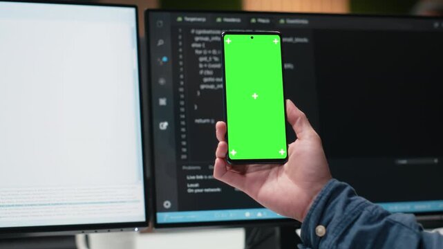 Isolated screen mobile phone used by admin in workplace doing tech quality assurance with coding and programming workflow for chroma key screen replacement.