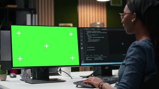 Green screen mockup computer used by programmer typing code, developing machine learning models to automate tasks with coding and programming workflow.