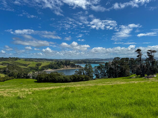 Rolling Green Hills and Coastal Inlet in New Zealand © Irina