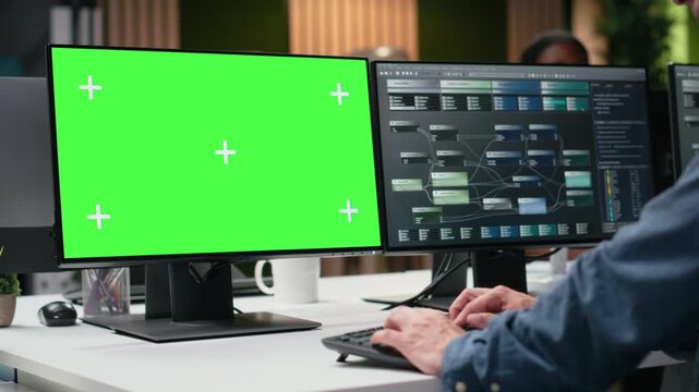 Green screen mockup PC used by admin in office analyzing machine learning. Tech agency IT worker reviewing code on chroma key computer to improve AI.