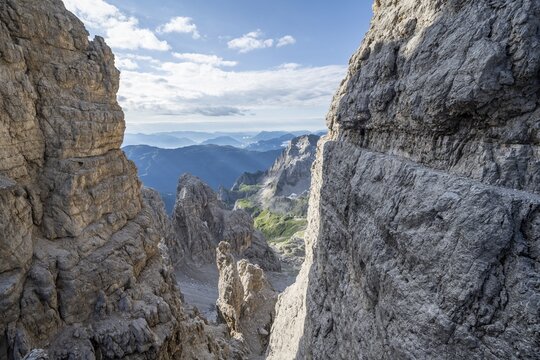 View from the Bocca degli Armi gap, mountaineers on a rock band on the Via Ferrata Bocciere Centrale via ferrata, Brenta Mountains, Brenta-Adamello Natural Park, Trentino, Italy