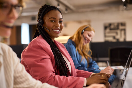 Portrait of African customer service woman smiling at call center