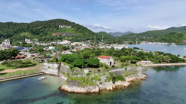 Aerial drone view of Fort Santa Isabel reveals the coral-stone Spanish fortress along Taytays tranquil coast, Philippines