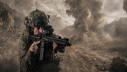 Obraz premium Soldier in tactical gear aiming a rifle during a military operation in a rocky terrain with dust and debris swirling in the background