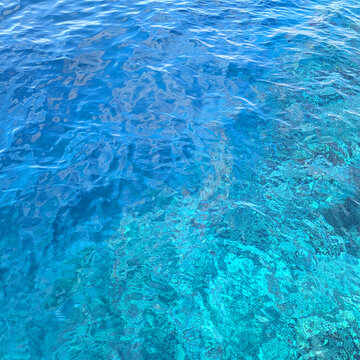 A vibrant blue water surface with clear ripples and reflections, showcasing the natural texture of the sea.