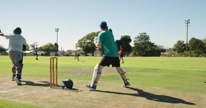 Diverse teammates defending delivery on pitch, wicketkeeper collecting ball, appealing dismissal