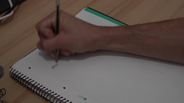 person writing with a pen in a notebook. High quality 4k footage