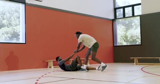 Starting 1-on-1 drill, two men dribbling ball crossovers for practice at gym