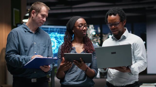 Portrait of smiling engineers in office developing machine learning algorithms simulating human brain thought processes. Happy coworkers deploy AI tools, perform software quality assurance.