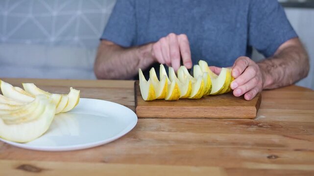 Man creating decorative cuts in melon wedge for elegant fruit serving video Full HD