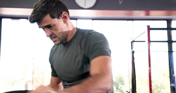 Diverse men pushing and pulling elliptical handles in gym improving fitness