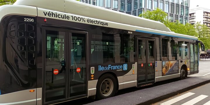 Modern electric Paris city bus parked at urban street stop