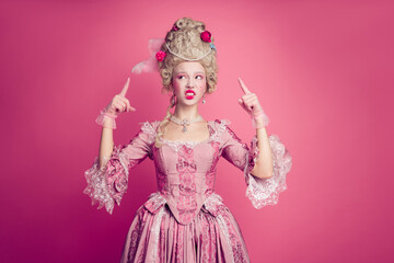 Fototapeta premium Photo of upset lady point finger wig not like antique style look wearing dress corset isolated pink color background