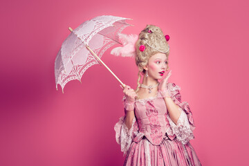 Fototapeta premium Photo of charming impressed marie antoinette wear rich dress rising umbrella looking empty space isolated pink color background