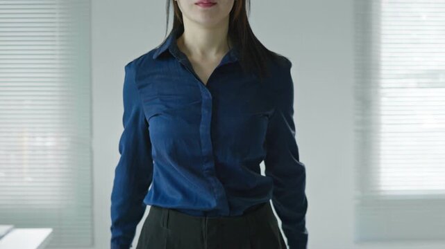 Business woman crossing clenched fists in an X shape, symbolizing strong rejection, prohibition, resistance, security warning, protection and defense concepts.