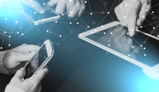 People hands using mobile phones and digital tablet; light effect