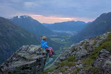Fototapeta premium Family with children and dog, hiking in Litlefjellet on sunset, enjoying amazing view from the top of hiking trail