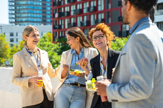 Diverse business team sharing an outdoor lunch break