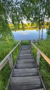 First-person shooting down a wooden path to the river