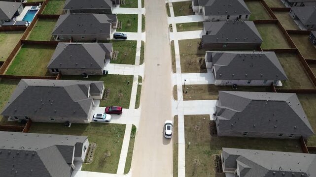 Suburban Street View reveals Highpointe Ranch subdivision homes flanking wide concrete roadway. Dark composite shingle roof lines contrast manicured lawns, pale concrete driveways, Aubrey, TX