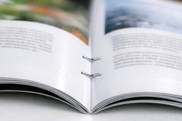 Fototapeta premium A person reading with a bookmark, perfect for education or literature themes
