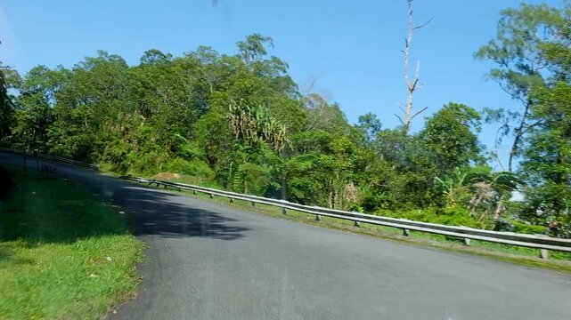 Driving into Panguna mine town on winding rough bumpy road in Bougainville, Papua New Guinea