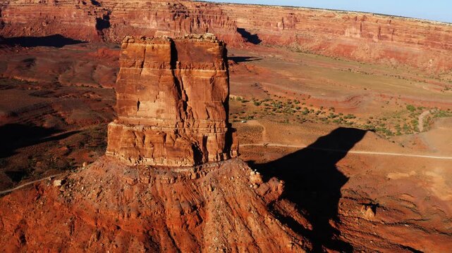 Drone aerial circling shot of rock butte in Valley of the Gods, Utah near sunset.