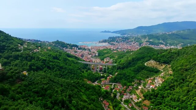 Aerial drone shot approaching coastal town of Rapallo from the Green Hills