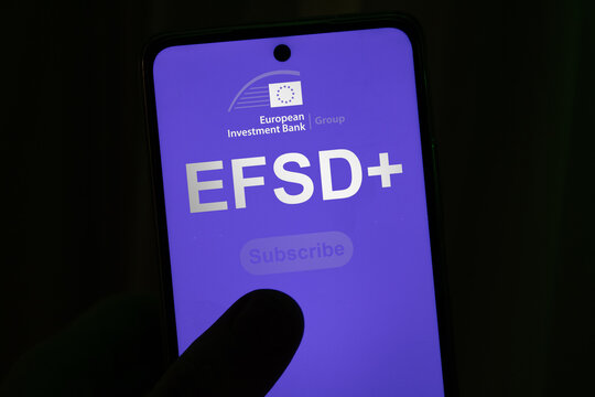 EFSD+ logo and website interface displayed on a smartphone screen held by a hand, European Investment Bank Group, close-up shot on a dark background.