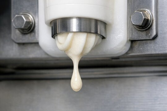 A close-up view of a machine with liquid flowing out, suitable for use in industrial or mechanical context