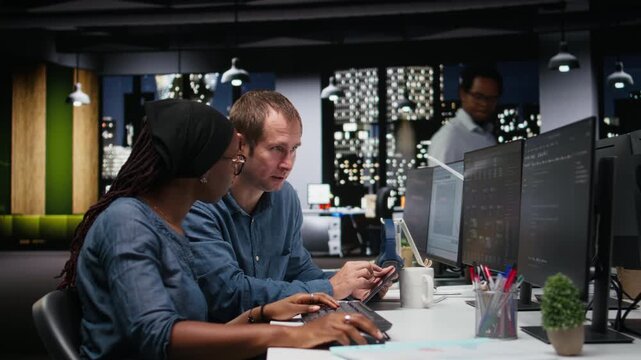 Tech startup colleagues brainstorming ways to optimize performance in office. Programmers use advanced machine learning APIs for debugging, typing lines of code for coding workflows.