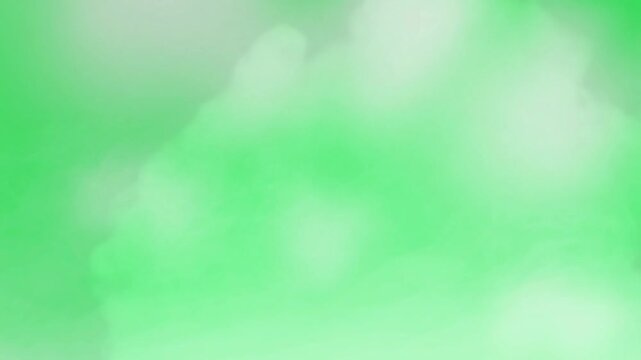 Cloud formations drift across a vibrant green background providing a clean and versatile template for digital design projects that require a natural atmospheric element with ample empty composition.