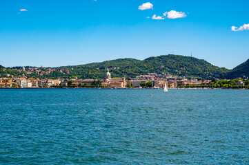 Fototapeta premium The city of Como, photographed in summer, with the lakeside, the cathedral, and the surrounding mountains.