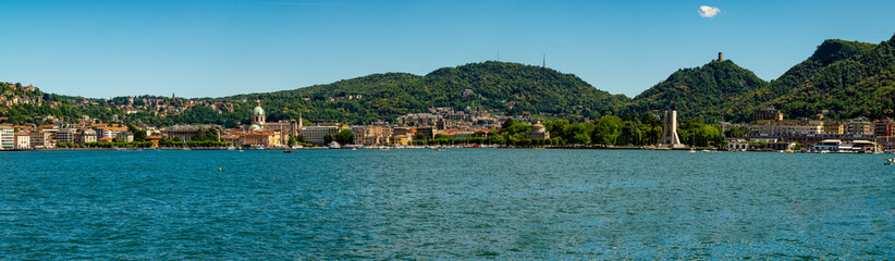 Fototapeta premium The city of Como, photographed in summer, with the lakeside, the cathedral, and the surrounding mountains.