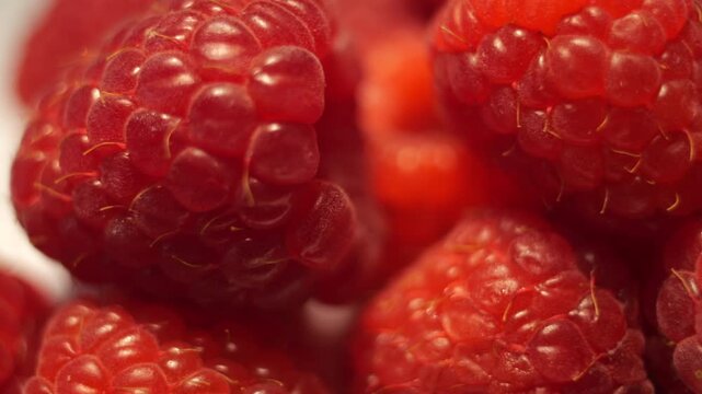 50p extreme close up slider shot moving across fresh raspberries texture