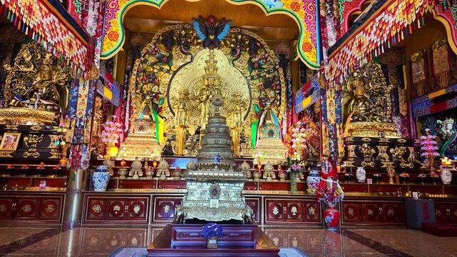 Ornate Buddhist altar and statues inside Fuguo Monastery prayer hall