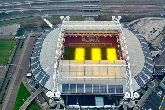True top-down aerial drone view of Johan Cruyff Arena oval form, AFC Ajax stadium and ArenA Boulevard entertainment district, Amsterdam, Netherlands